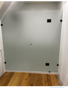 Frosted between walls frameless with black fittings